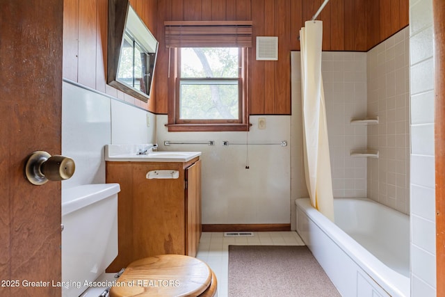 3129 Birch Row Dr, East Lansing, MI 48823 - full bathroom with toilet, vanity, shower / tub combo with curtain, and wooden walls