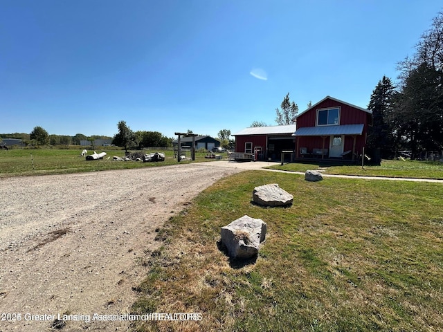 13862 Hartel Rd, Grand Ledge, MI 48837 - view of front of house with dirt driveway and a front lawn