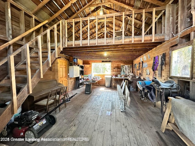 13862 Hartel Rd, Grand Ledge, MI 48837 - miscellaneous room featuring high vaulted ceiling, hardwood / wood-style flooring, and wood walls