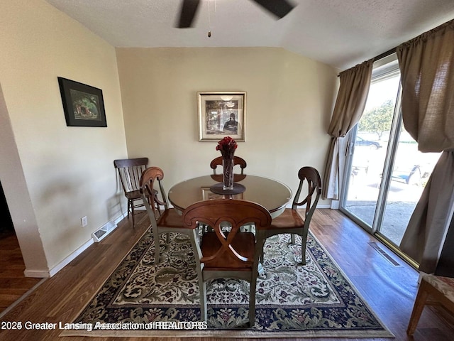 13862 Hartel Rd, Grand Ledge, MI 48837 - dining space with a ceiling fan, wood finished floors, lofted ceiling, baseboards, and a textured ceiling
