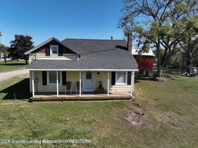 13862 Hartel Rd, Grand Ledge, MI 48837 - view of front of home with a shingled roof, a chimney, a front lawn, and a porch