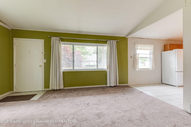 6394 Stephen, Brighton, MI 48116 - unfurnished living room featuring light colored carpet, baseboards, and light tile patterned flooring