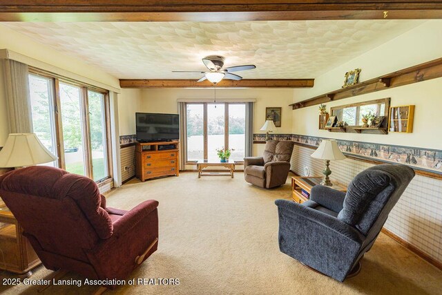 2278 Narrow Lake Rd, Charlotte, MI 48813 - living room with light carpet, beam ceiling, and a ceiling fan