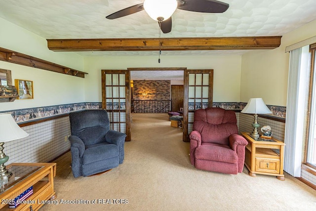 2278 Narrow Lake Rd, Charlotte, MI 48813 - living room with carpet flooring, french doors, wainscoting, beam ceiling, and a ceiling fan