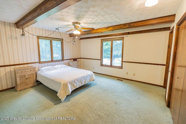 2278 Narrow Lake Rd, Charlotte, MI 48813 - carpeted bedroom featuring beamed ceiling, wallpapered walls, and baseboards