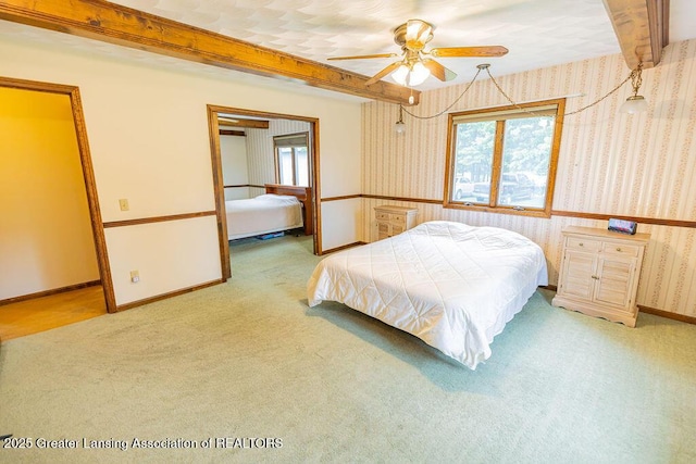 2278 Narrow Lake Rd, Charlotte, MI 48813 - carpeted bedroom with multiple windows, wallpapered walls, beamed ceiling, baseboards, and a ceiling fan