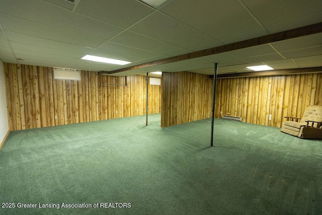 2278 Narrow Lake Rd, Charlotte, MI 48813 - finished basement with carpet floors, a drop ceiling, wooden walls, and a baseboard heating unit