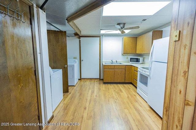 2278 Narrow Lake Rd, Charlotte, MI 48813 - kitchen featuring white appliances, washer / clothes dryer, light countertops, light wood-style flooring, and a ceiling fan