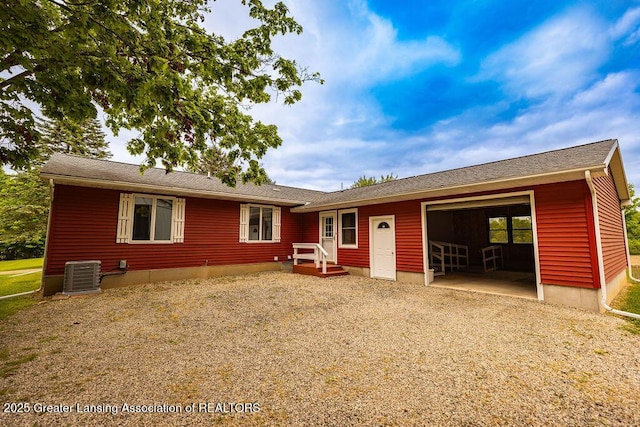 2278 Narrow Lake Rd, Charlotte, MI 48813 - view of front of home featuring an attached garage, cooling unit, and gravel driveway