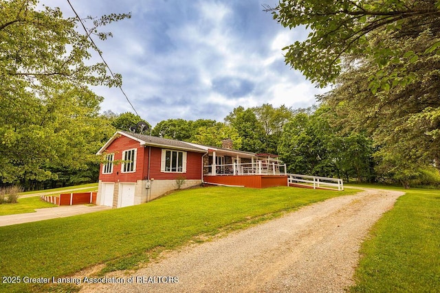 2278 Narrow Lake Rd, Charlotte, MI 48813 - view of front facade with concrete driveway, a chimney, a garage, and a front yard