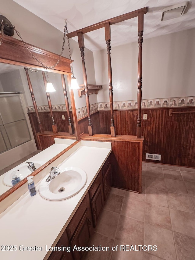 2278 Narrow Lake Rd, Charlotte, MI 48813 - bathroom with wainscoting, vanity, wood walls, and tile patterned floors