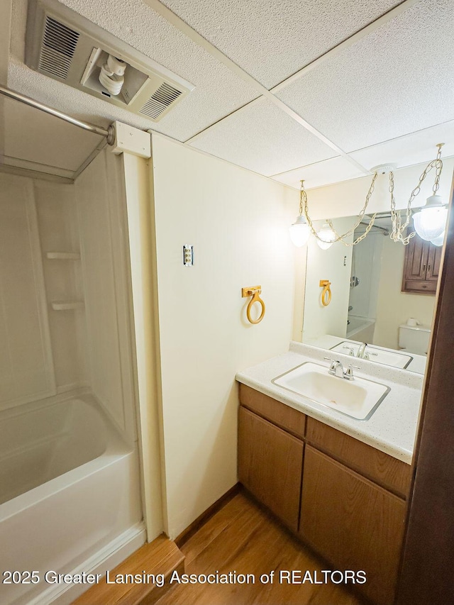 2278 Narrow Lake Rd, Charlotte, MI 48813 - full bath featuring wood finished floors, vanity,  shower combination, and baseboards