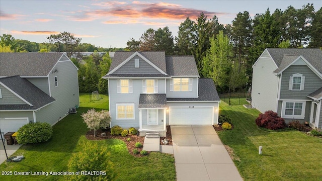 4026 Watts Ln, Lansing, MI 48911 - traditional home with concrete driveway, a yard, and a shingled roof