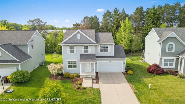 4026 Watts Ln, Lansing, MI 48911 - traditional-style home with concrete driveway, a garage, a front lawn, and roof with shingles