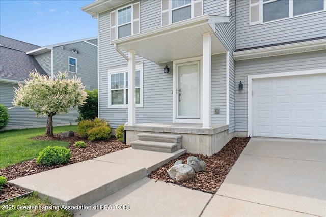 4026 Watts Ln, Lansing, MI 48911 - view of exterior entry featuring a porch and an attached garage