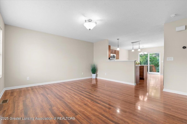 4026 Watts Ln, Lansing, MI 48911 - unfurnished living room with wood finished floors and baseboards