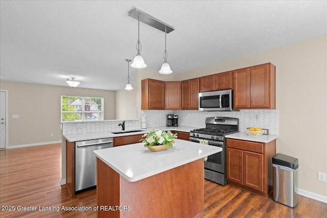 4026 Watts Ln, Lansing, MI 48911 - kitchen featuring stainless steel appliances, decorative backsplash, light countertops, and dark wood-style flooring