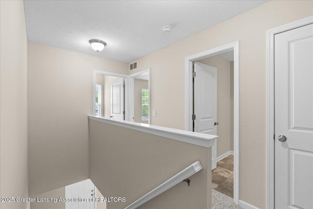 4026 Watts Ln, Lansing, MI 48911 - hall with an upstairs landing and a textured ceiling