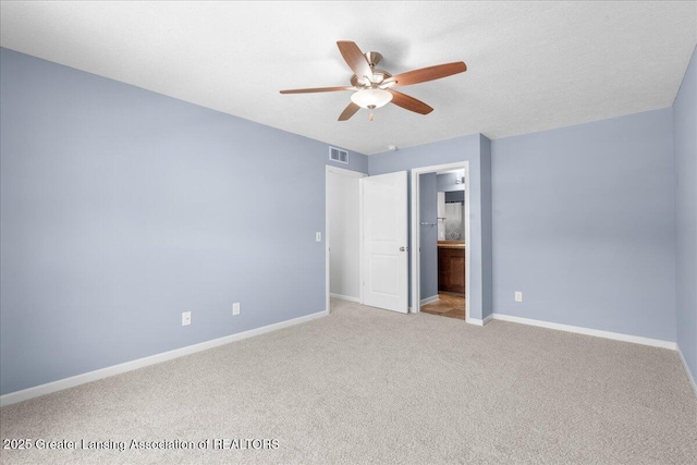 4026 Watts Ln, Lansing, MI 48911 - unfurnished bedroom featuring carpet floors, baseboards, ensuite bathroom, and a ceiling fan
