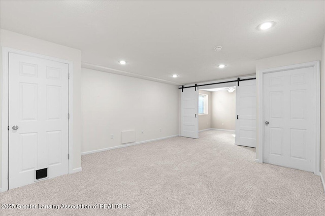 4026 Watts Ln, Lansing, MI 48911 - unfurnished bedroom featuring light colored carpet, recessed lighting, a barn door, and baseboards
