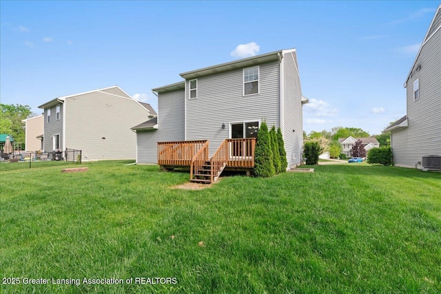 4026 Watts Ln, Lansing, MI 48911 - rear view of property with a deck, a lawn, and central AC