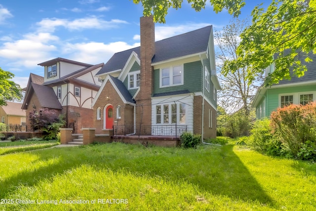 414 W St, Lansing, MI 48915 - view of front of home with a chimney and brick siding