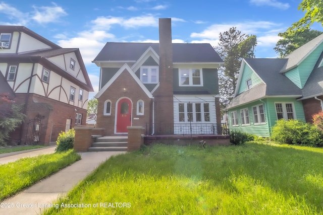 414 W St, Lansing, MI 48915 - tudor-style house with a chimney
