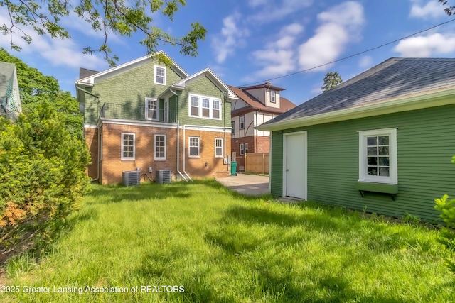 414 W St, Lansing, MI 48915 - back of property with central AC unit, a patio area, and brick siding