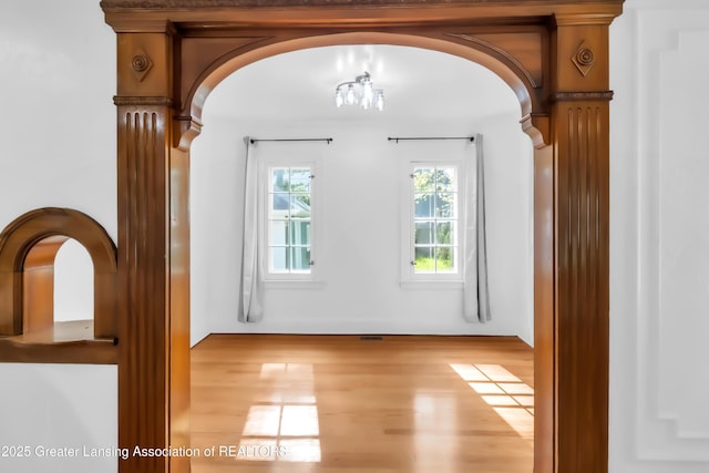 414 W St, Lansing, MI 48915 - empty room featuring wood finished floors and arched walkways