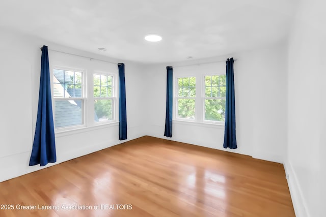 414 W St, Lansing, MI 48915 - empty room with healthy amount of natural light and wood finished floors