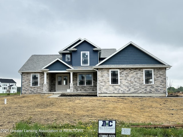 9135 Klein Farm, Grand Ledge, MI 48837 - craftsman house with stone siding, french doors, and covered porch