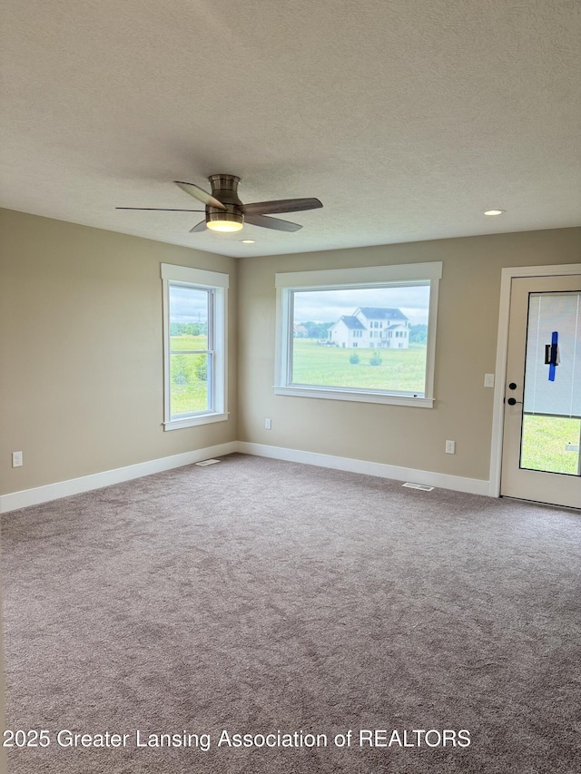 9135 Klein Farm, Grand Ledge, MI 48837 - spare room featuring carpet flooring, a textured ceiling, baseboards, and ceiling fan