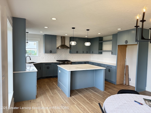 9135 Klein Farm, Grand Ledge, MI 48837 - kitchen featuring wall chimney exhaust hood, a kitchen island, decorative backsplash, stainless steel range with gas stovetop, and recessed lighting