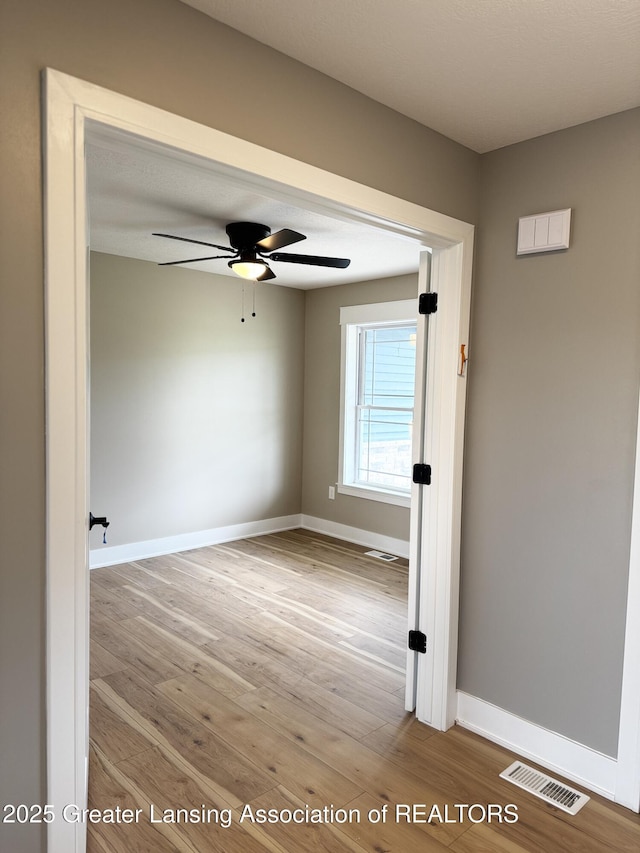 9135 Klein Farm, Grand Ledge, MI 48837 - spare room with wood finished floors, ceiling fan, and baseboards