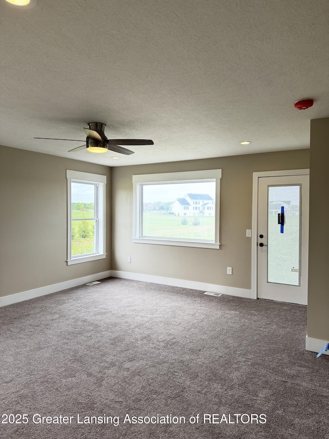 9135 Klein Farm, Grand Ledge, MI 48837 - carpeted spare room with a textured ceiling, baseboards, and a ceiling fan