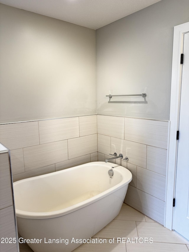 9135 Klein Farm, Grand Ledge, MI 48837 - bathroom with a soaking tub, tile walls, and tile patterned floors