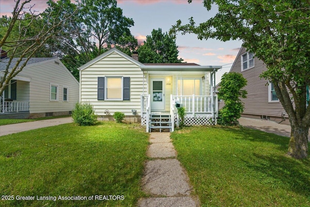 1200 W Rundle Ave, Lansing, MI 48910 - bungalow with a porch, a front lawn, and a chimney