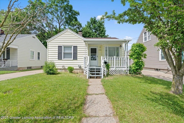 1200 W Rundle Ave, Lansing, MI 48910 - bungalow featuring covered porch, a front yard, and a chimney
