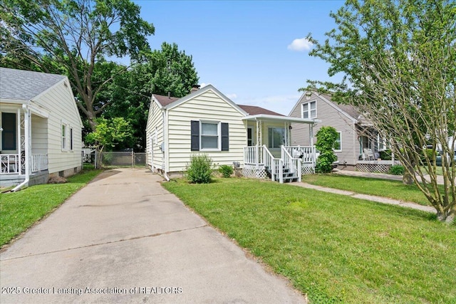 1200 W Rundle Ave, Lansing, MI 48910 - view of front of property with covered porch, driveway, and a front lawn