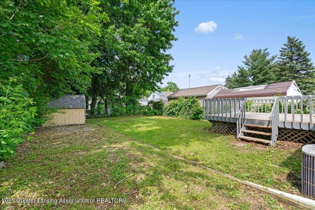 1200 W Rundle Ave, Lansing, MI 48910 - view of grassy yard with a deck and cooling unit