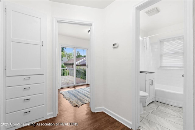 1200 W Rundle Ave, Lansing, MI 48910 - hallway featuring baseboards and wood finished floors