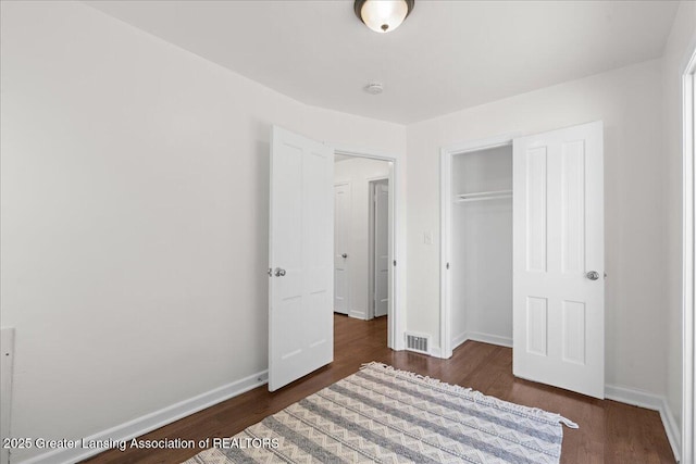 1200 W Rundle Ave, Lansing, MI 48910 - unfurnished bedroom with wood finished floors, a closet, and baseboards