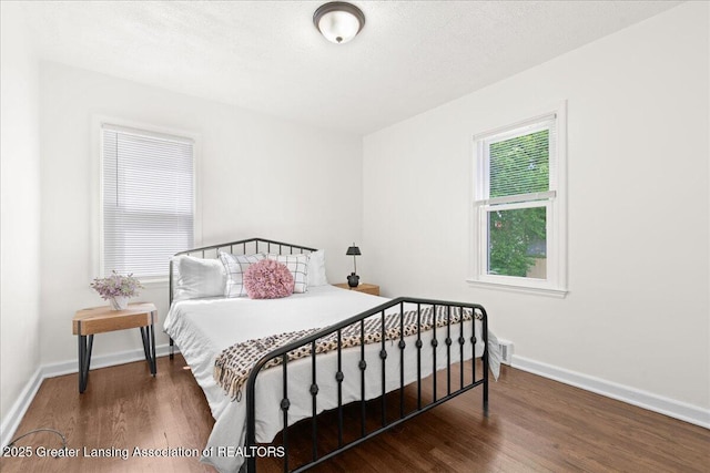 1200 W Rundle Ave, Lansing, MI 48910 - bedroom featuring wood finished floors, baseboards, and a textured ceiling