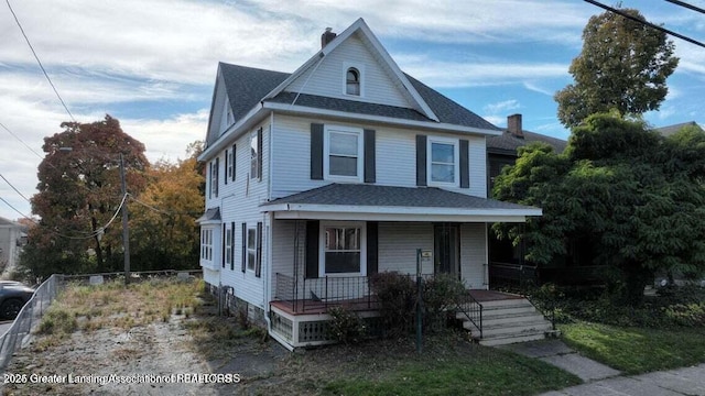411 W Ionia St, Lansing, MI 48933 - view of front of home with a porch, a shingled roof, and a chimney