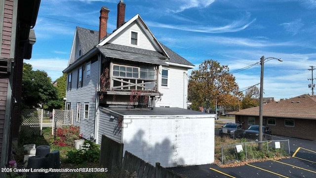 411 W Ionia St, Lansing, MI 48933 - view of property exterior featuring uncovered parking and roof with shingles