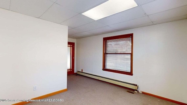 411 W Ionia St, Lansing, MI 48933 - spare room featuring a baseboard heating unit, a drop ceiling, carpet floors, and baseboards