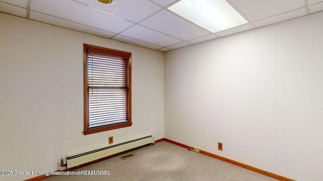 411 W Ionia St, Lansing, MI 48933 - carpeted empty room with baseboard heating, a paneled ceiling, and baseboards