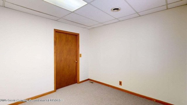 411 W Ionia St, Lansing, MI 48933 - unfurnished room with light colored carpet, a paneled ceiling, and baseboards