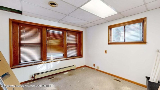 411 W Ionia St, Lansing, MI 48933 - unfurnished room featuring a baseboard radiator, baseboards, carpet, and a drop ceiling