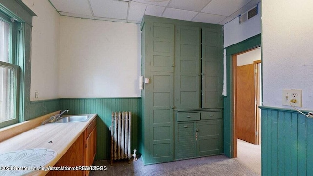 411 W Ionia St, Lansing, MI 48933 - bathroom featuring radiator, a sink, a wainscoted wall, and a paneled ceiling